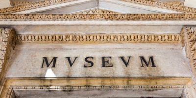 Entrance of an ancient museum, letters on original marble
